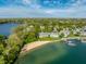 Gray townhouses, sandy beach, and docks create a tranquil lakeside community with easy access to water activities at 7849 Clearwater Cove Dr, Indianapolis, IN 46240