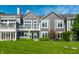 Lush backyard with stone path leading to gray two-story home featuring well-manicured lawn and garden at 7849 Clearwater Cove Dr, Indianapolis, IN 46240