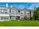 Well-maintained backyard showcasing gray two-story home with lush lawn, and mature trees at 7849 Clearwater Cove Dr, Indianapolis, IN 46240