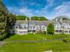 Lush green lawn and pathway complement the gray exterior of these gorgeous townhouses at 7849 Clearwater Cove Dr, Indianapolis, IN 46240