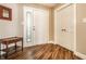 Inviting foyer with hardwood floors, a decorative mirror, and convenient closet space at 7849 Clearwater Cove Dr, Indianapolis, IN 46240
