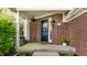 Charming front porch with brick details and a welcoming entrance, featuring flowers at 7849 Clearwater Cove Dr, Indianapolis, IN 46240
