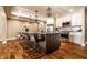 Spacious eat-in kitchen features stainless appliances, white cabinets and a large island with bar seating at 7849 Clearwater Cove Dr, Indianapolis, IN 46240