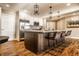 Beautiful eat-in kitchen boasts stainless appliances, white cabinets and a large island with seating at 7849 Clearwater Cove Dr, Indianapolis, IN 46240
