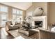 Bright living room features a fireplace, a large window and a stylish, comfortable looking sofa at 7849 Clearwater Cove Dr, Indianapolis, IN 46240
