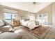 Sun-filled main bedroom features water views, neutral decor and a comfortable sitting area at 7849 Clearwater Cove Dr, Indianapolis, IN 46240