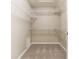 Spacious walk-in closet with white wire shelving offering ample storage, and neutral carpeting at 7849 Clearwater Cove Dr, Indianapolis, IN 46240