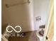 Small bathroom with a toilet and a sink against a white wall, showing signs of deferred maintenance at 7916 Catawba Ct, Indianapolis, IN 46217