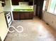 Functional kitchen featuring a refrigerator, oven, dark cabinets, and a convenient access door at 7916 Catawba Ct, Indianapolis, IN 46217