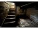 Basement stairs leading down to a dark, unfinished basement with stone walls and concrete floor at 811 N Oxford St, Indianapolis, IN 46201