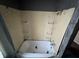 Bathroom with tiled shower and a curtain and white tub at 811 N Oxford St, Indianapolis, IN 46201