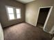 Bedroom with two windows and an open doorway leading to another room at 811 N Oxford St, Indianapolis, IN 46201