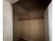 Small storage closet featuring wooden shelves and paneling at 811 N Oxford St, Indianapolis, IN 46201