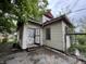 Exterior view of home with overgrown trees and an abandoned look at 811 N Oxford St, Indianapolis, IN 46201