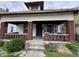 A charming, craftsman-style home featuring a cozy front porch with brick columns and steps at 811 N Oxford St, Indianapolis, IN 46201