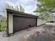 Garage exterior, showing large damaged door in need of repair and an unkempt appearance at 811 N Oxford St, Indianapolis, IN 46201
