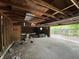 Unfinished garage with exposed wood framing, unfinished drywall and access to backyard at 811 N Oxford St, Indianapolis, IN 46201