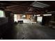 Wide angle shot of an unfinished garage with wooden beams, exposed studs, and concrete flooring at 811 N Oxford St, Indianapolis, IN 46201