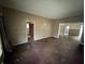 Spacious living room with classic carpet and multiple doorways, providing plenty of natural light at 811 N Oxford St, Indianapolis, IN 46201