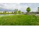 Backyard with lush green lawn leading to a pond and a wooden deck at 8269 S Midnight Dr, Pendleton, IN 46064