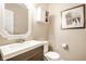 Bathroom with a decorative mirror, storage cabinet, modern sink, and framed buffalo art at 8269 S Midnight Dr, Pendleton, IN 46064