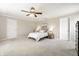 Spacious main bedroom with a ceiling fan, neutral colored walls and carpet and two closets at 8269 S Midnight Dr, Pendleton, IN 46064