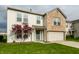 Two-story home with a brick facade, manicured lawn, and mature landscaping at 8269 S Midnight Dr, Pendleton, IN 46064
