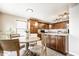 Eat-in kitchen featuring dark wood cabinets, stainless steel appliances, and a four-chair dining set at 8269 S Midnight Dr, Pendleton, IN 46064