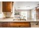 Kitchen featuring granite countertops, stainless steel sink, and wood cabinets at 8269 S Midnight Dr, Pendleton, IN 46064