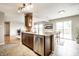 Open kitchen features a kitchen island with stainless steel dishwasher and view to the backyard deck at 8269 S Midnight Dr, Pendleton, IN 46064