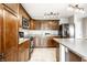 Well-lit kitchen features dark wood cabinets, stainless steel appliances and light-colored countertops at 8269 S Midnight Dr, Pendleton, IN 46064