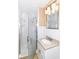 Bathroom with glass shower, vanity with granite countertop, and decorative lighting at 8606 N Washington Blvd, Indianapolis, IN 46240