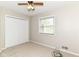 Carpeted bedroom with closet, ceiling fan, and window at 8606 N Washington Blvd, Indianapolis, IN 46240
