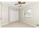 Bedroom features carpet, closet, window, ceiling fan and tan paint at 8606 N Washington Blvd, Indianapolis, IN 46240