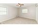Spacious bedroom with neutral carpet, ceiling fan, and a bright window at 8606 N Washington Blvd, Indianapolis, IN 46240