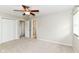 This bedroom features carpet floors, neutral walls, a ceiling fan, and an ensuite bathroom at 8606 N Washington Blvd, Indianapolis, IN 46240