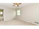 Bedroom features carpet, a ceiling fan, and a large window at 8606 N Washington Blvd, Indianapolis, IN 46240