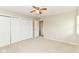 This bedroom offers carpet floors, neutral walls, a ceiling fan, and a closet for ample storage at 8606 N Washington Blvd, Indianapolis, IN 46240