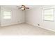 This bedroom has carpet floors, neutral walls, a ceiling fan, and two windows at 8606 N Washington Blvd, Indianapolis, IN 46240