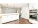 Bright kitchen features granite countertops, stainless appliances, and dark wood-look flooring at 8606 N Washington Blvd, Indianapolis, IN 46240