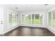 Bright living room with hardwood floors and large windows offering a view of the front yard at 8606 N Washington Blvd, Indianapolis, IN 46240