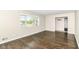 Bright living room featuring hardwood floors, a large window, and a view into a closet at 8606 N Washington Blvd, Indianapolis, IN 46240