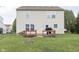 Home backyard has a raised wooden deck with a grill, grassy area and a fire pit at 8709 Orchard Grove Ln, Camby, IN 46113