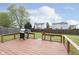 Backyard with a deck and grill and an expanse of grass between houses at 8709 Orchard Grove Ln, Camby, IN 46113