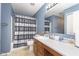 En-suite bathroom featuring a vanity with lots of counter space and a shower and tub combo at 8709 Orchard Grove Ln, Camby, IN 46113