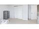 Neutral bedroom features carpet flooring, white sliding closet doors, and closet organizer at 8709 Orchard Grove Ln, Camby, IN 46113