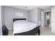 This neutral bedroom has carpet flooring and gray walls with a queen sized bed at 8709 Orchard Grove Ln, Camby, IN 46113
