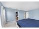 Bright bedroom with blue accent walls, carpet, and access to an en-suite bathroom at 8709 Orchard Grove Ln, Camby, IN 46113