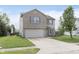 Inviting two-story home with a brick facade, a two-car garage and a well-kept lawn at 8709 Orchard Grove Ln, Camby, IN 46113