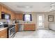 Eat-in kitchen with stainless appliances, a double sink, and a view of the fenced backyard at 8709 Orchard Grove Ln, Camby, IN 46113